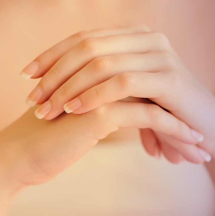 Hands smoothing in cream